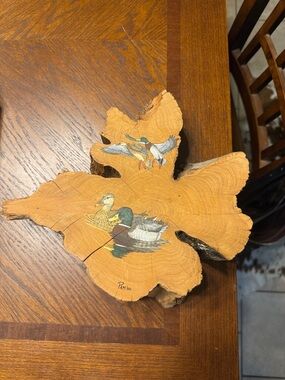 American folk art featuring hand-painted mallard ducks on a natural wood slice